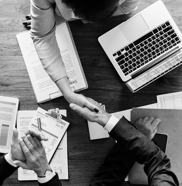 Business owner and accountant shaking hands talking about How To Claim Business Expenses